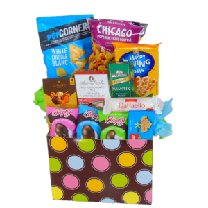 Sweet Snacks Gift Box Basket. Pink, blue, green, and yellow dots on a brown gift box filled with sweet snacks. This gift is the best for Happy Birthday, Get Well, Thank You, New Home, New Job, Congratulations, and any other occasion. Send this gift basket to someone who loves snacks. Gift box is filled with popcorn, chips, cookies, and chocolates. Gift Basket will be delivered with clear cello wrap, ribbon, and a gift tag message.